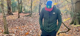 Man wearing The North Face Summit Series Futurefleece jacket and garish baseball cap in forest