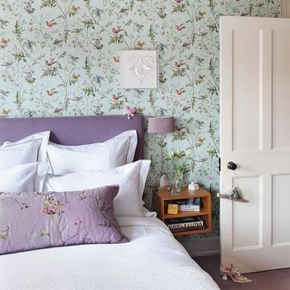 bedroom with wallpaper and lamp