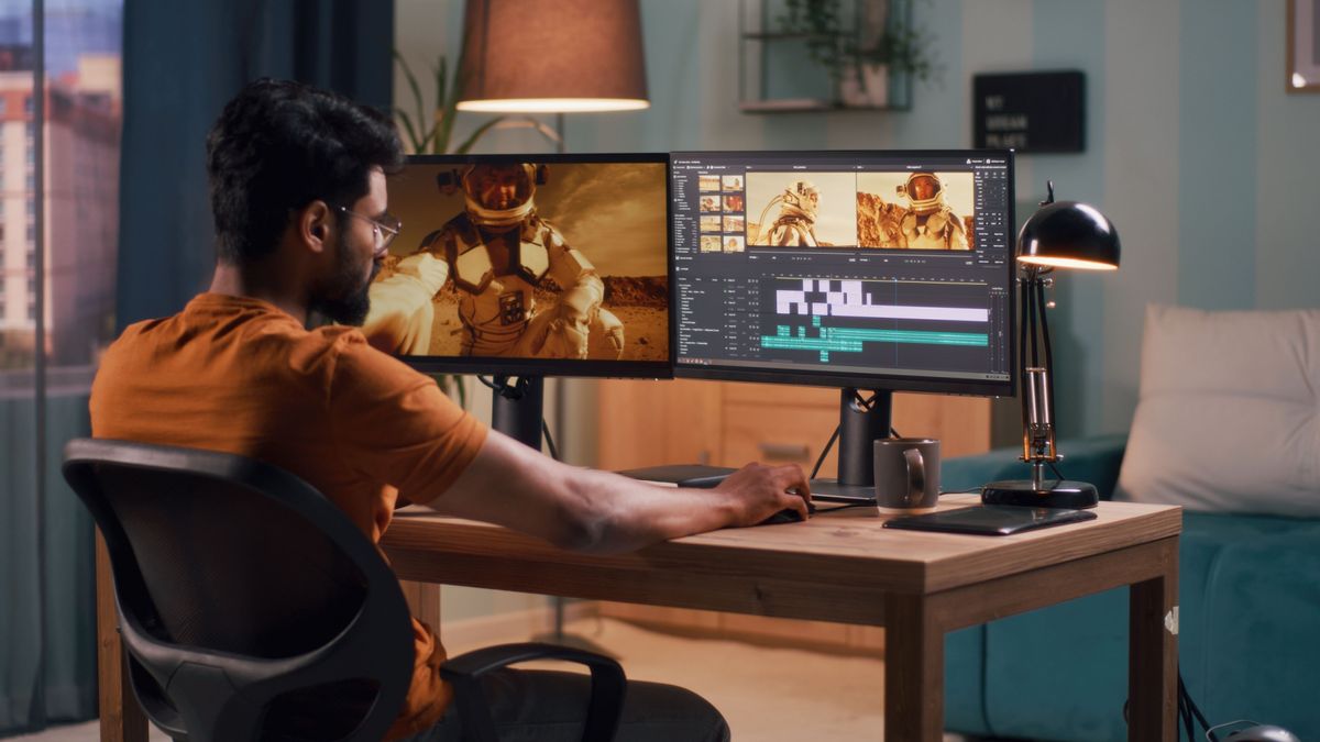 man editing video of an astronaut on a desktop PC