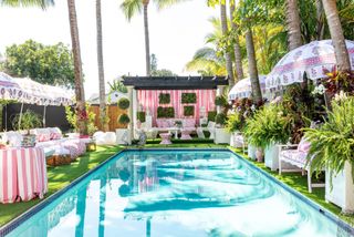 palm beach style pool with pink cabanas