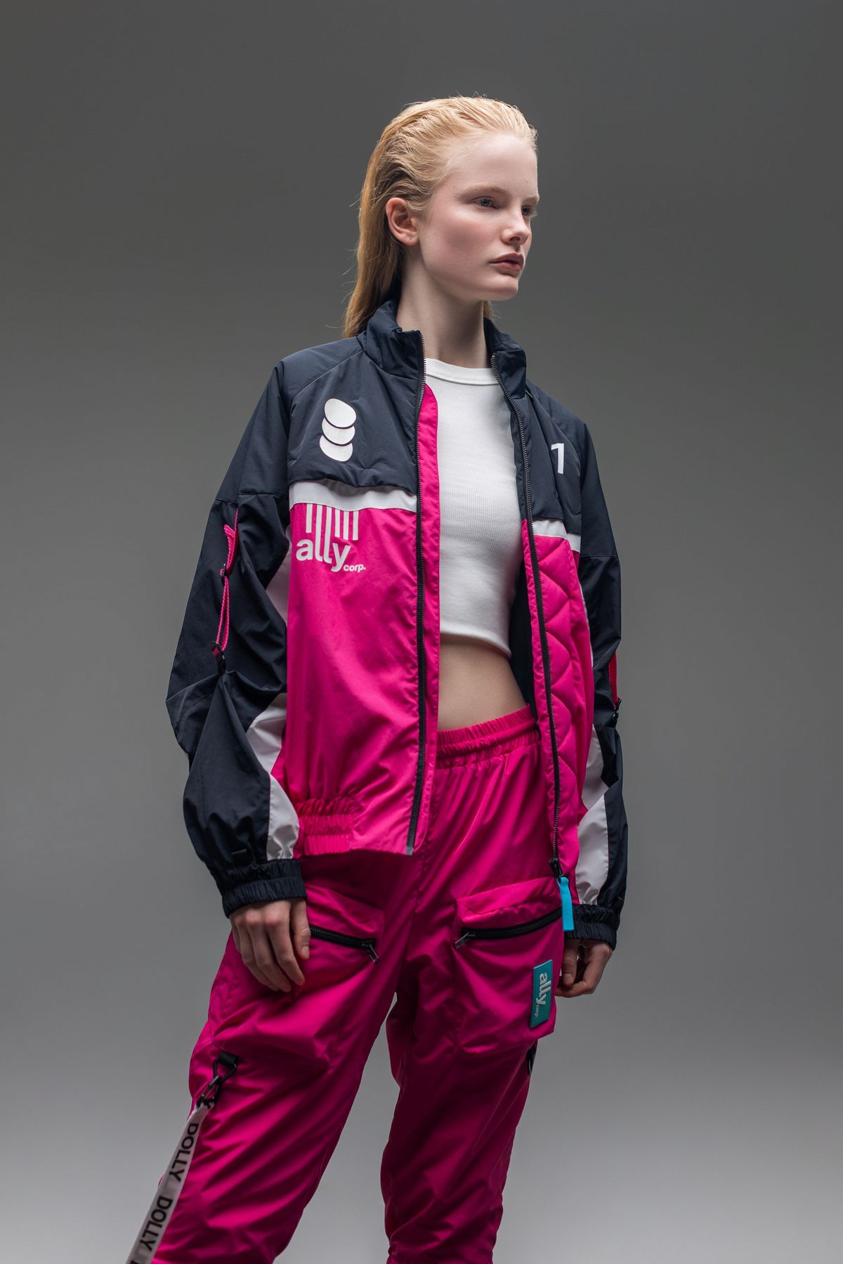 A female model wearing the full Alters tracksuit.