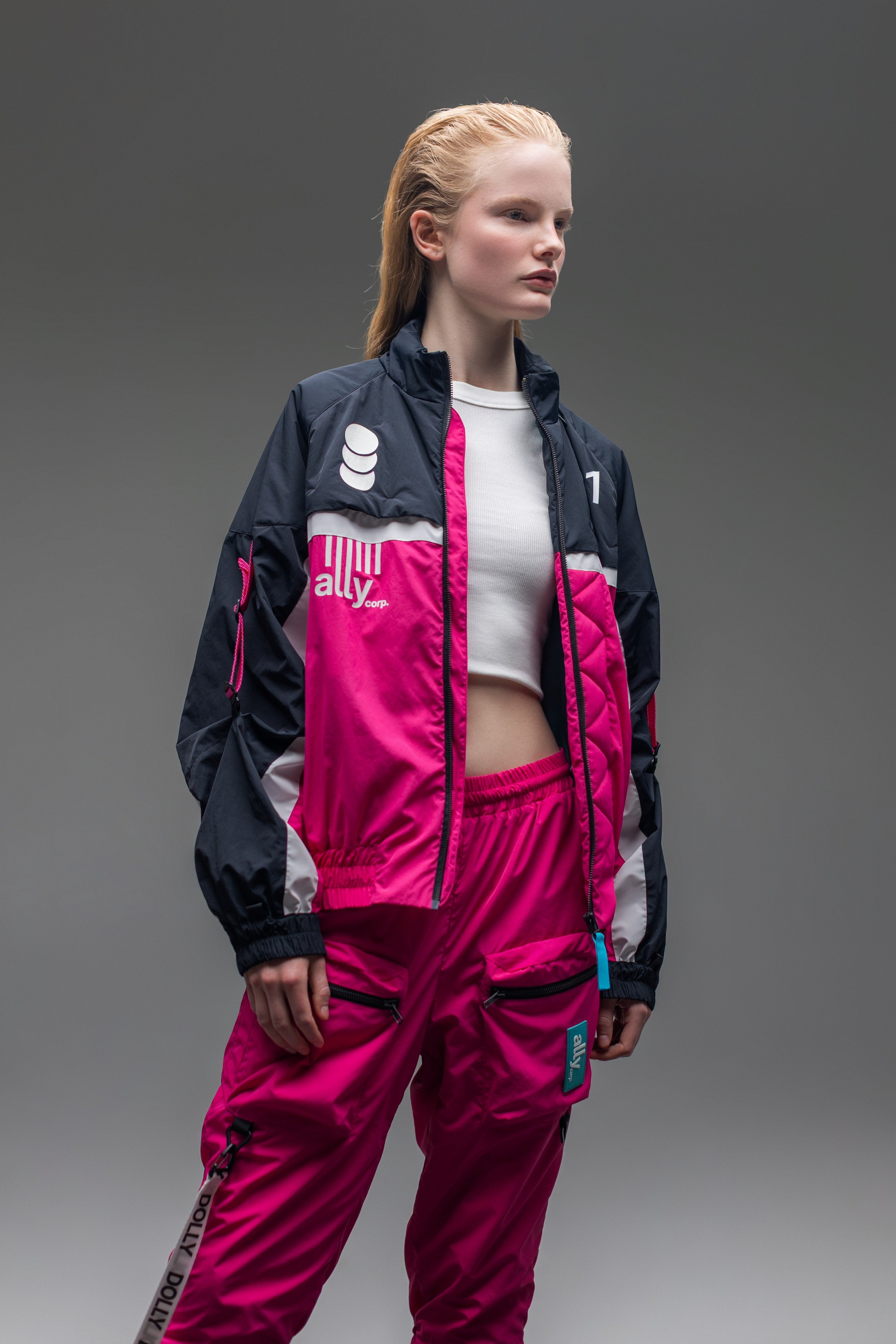 A female model wearing the full Alters tracksuit.