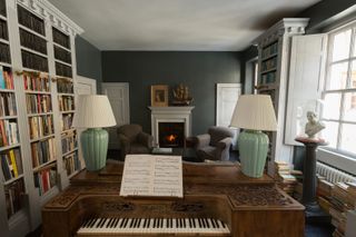 library in period home with piano and fireplace