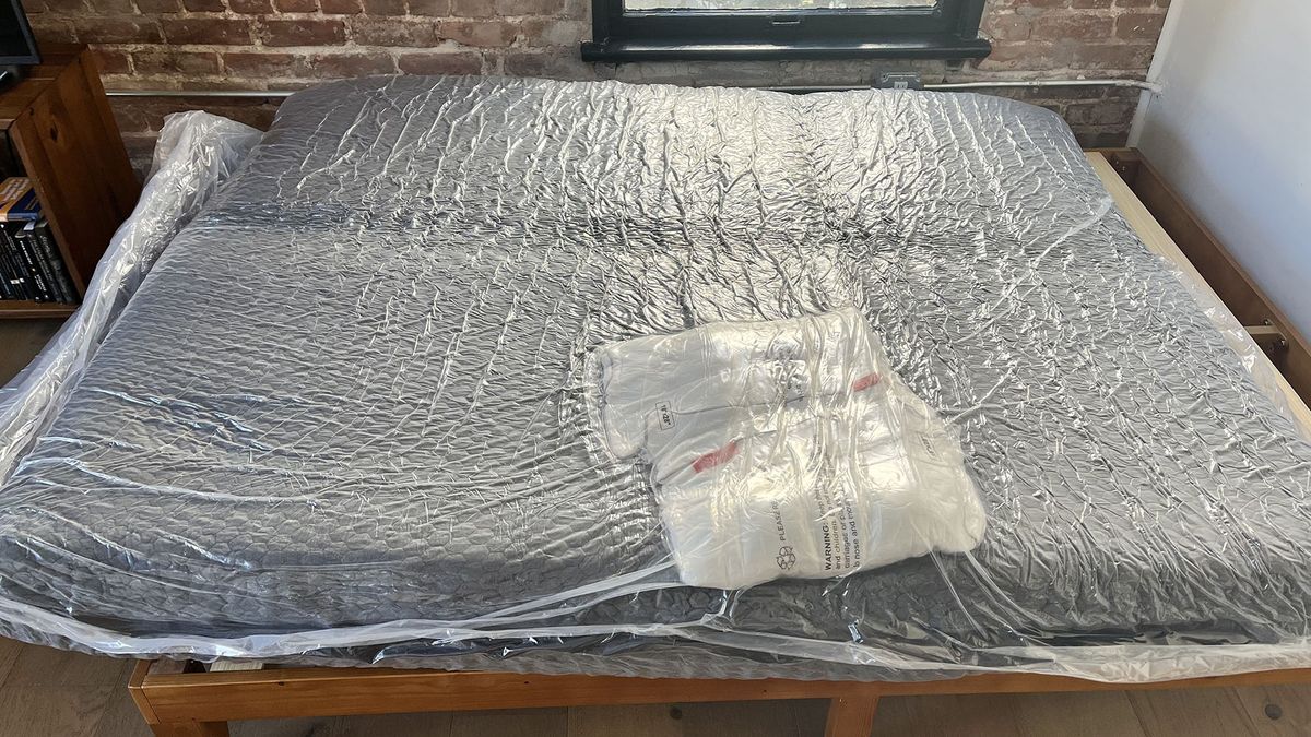 Layla Hybrid mattress in plastic on a bedframe