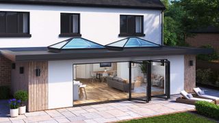 Wide shoot of contemporary extension with Korniche bi-fold doors and roof lanterns