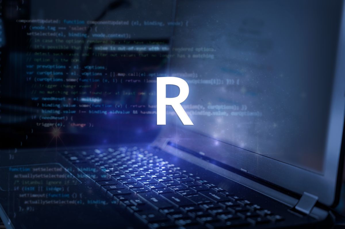 &amp;quot;R&amp;quot; over top of a laptop with code on it