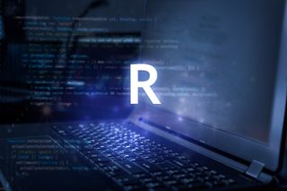 "R" over top of a laptop with code on it