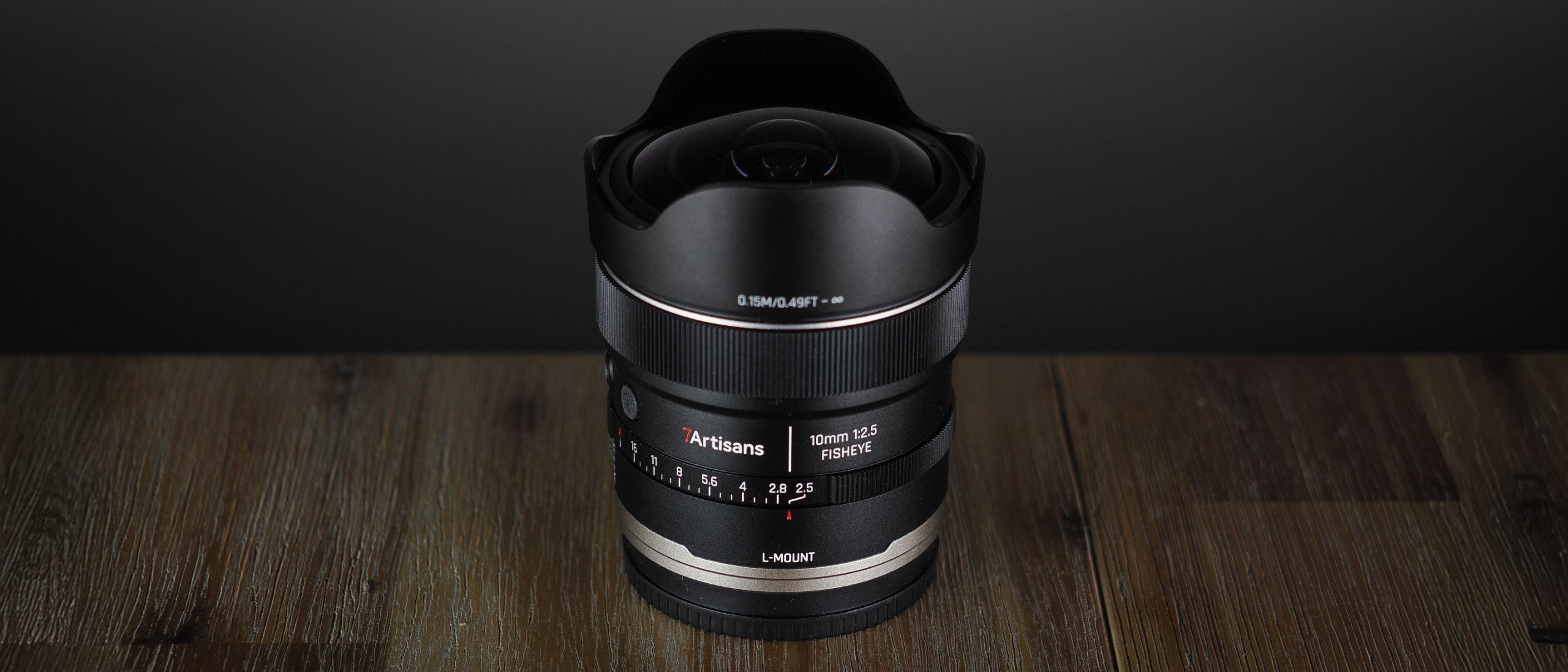 7Artisans AF 10mm f/2.5 Fisheye Max lens on a wooden surface