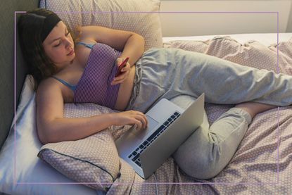 Teen lounging in bed with phone and laptop