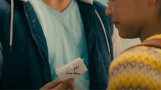 Peter handing Lara Jean a love note with her name on it