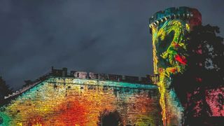 Warwick Castle The Dragon Slayer illustrated by amazing dragon on side of castle