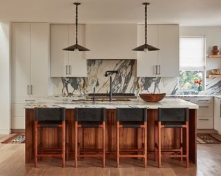 a white and wood kitchen with dramatic marble