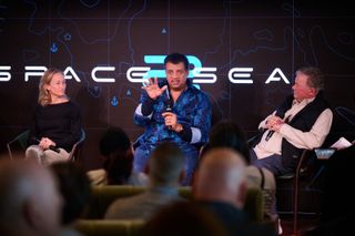 Astrophysicist Neil deGrasse Tyson gestures during a live webinar from the Drake Passage during the Space2Sea Antarctica voyage.