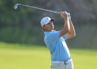 Preston Summerhays hits an iron shot during the 2025 Dubai Desert Classic