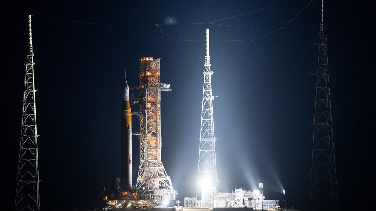 huge artemis 1 rocket on the launch pad at night