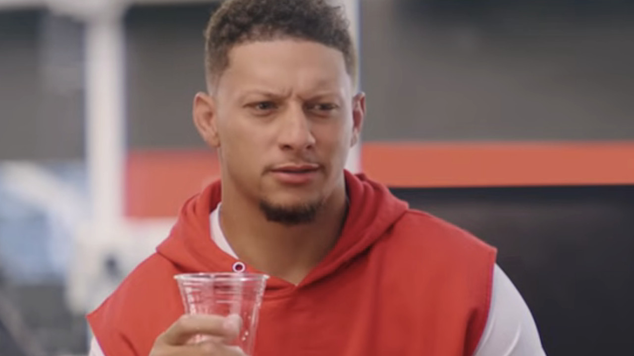 Patrick Mahomes drinks a glass of water and looks confused during a State Farm commercial.