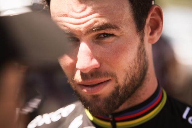 Mark Cavendish (Omega Pharma-Quickstep) peaks from behind a fan