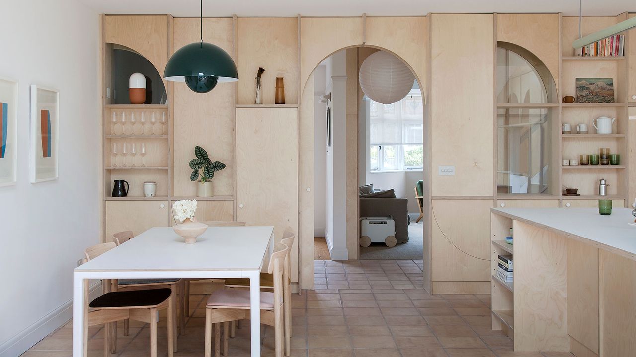 a kitchen diner with internal windows into a hallway