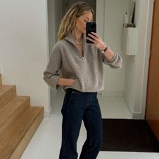 anouk yve wearing a quarter zip jumper