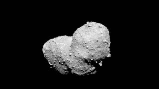 a rocky peanut-shaped asteroid in space