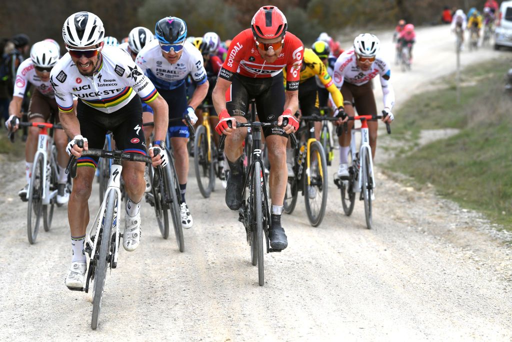 SIENA ITALY MARCH 05 LR Julian Alaphilippe of France and Team QuickStep Alpha Vinyl Simon Clarke of Australia and Team Israel Premier Tech and Tim Wellens of Belgium and Team Lotto Soudal compete during the Eroica 16th Strade Bianche 2022 Mens Elite a 184km one day race from Siena to Siena Piazza del Campo 321m StradeBianche WorldTour on March 05 2022 in Siena Italy Photo by Tim de WaeleGetty Images