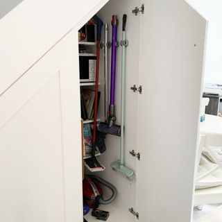 under stairs storage with vacuum cleaner.