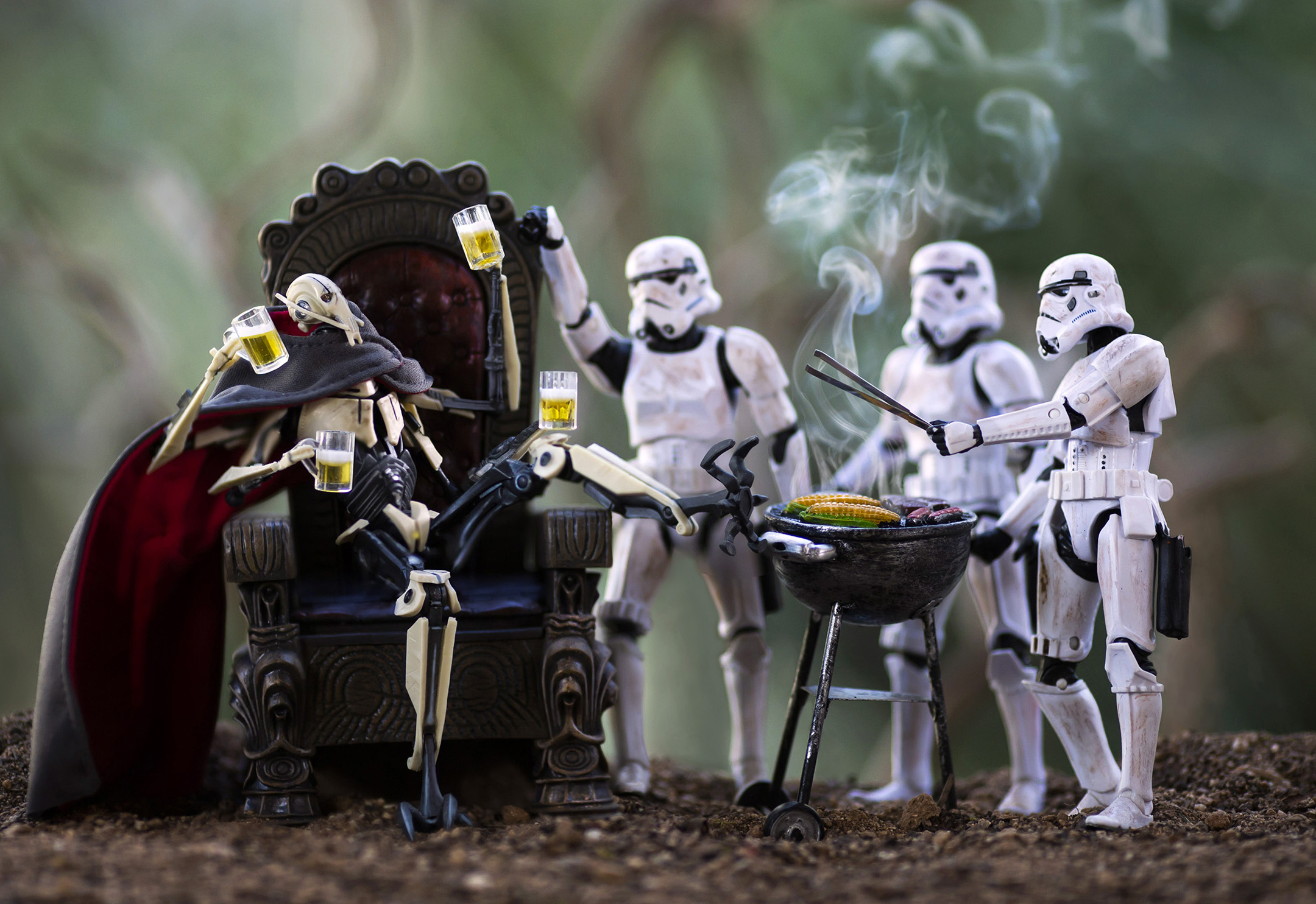 Star Wars action figures with General Grievous sitting and Stormtroopers grilling and toasting with drinks outdoors