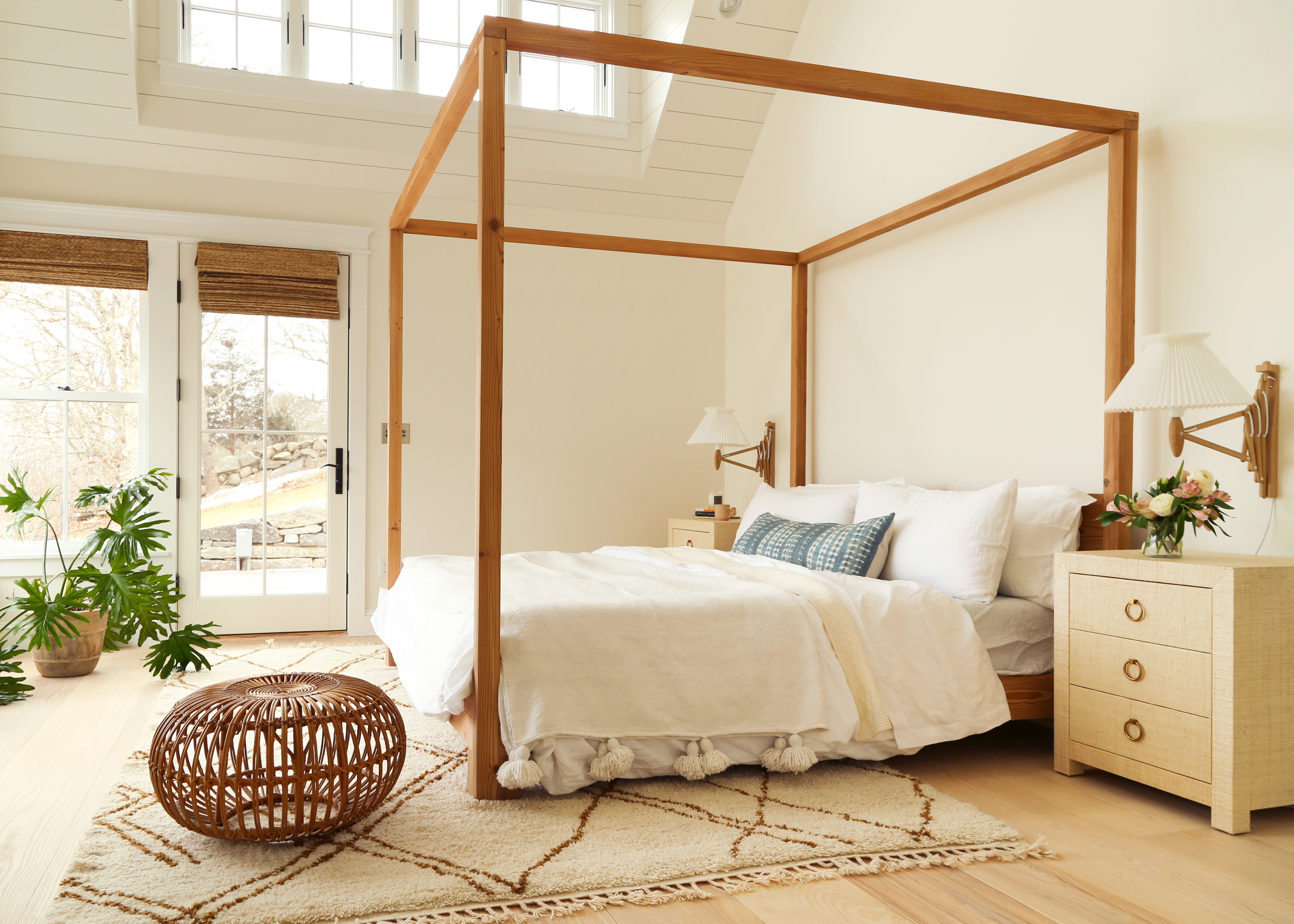 White bedroom with wooden four poster bed