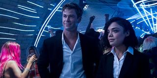 Chris Hemsworth and Tessa Thompson in a club in Men in Black: International