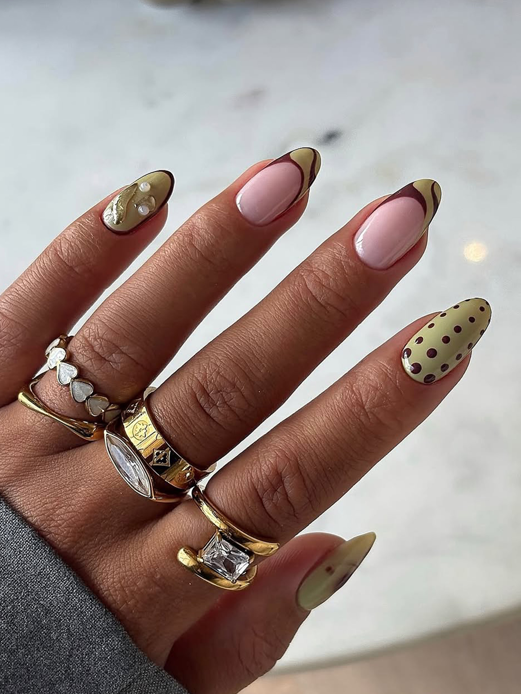 An almond manicure with a green, Y2K design by Stephanie Holland