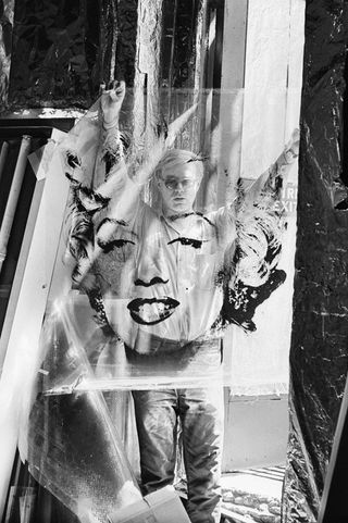 Warhol in 1964 holding the 'Marilyn' acetate used to make his famous 40” paintings