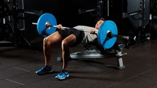 Man performs hip thrust with barbell