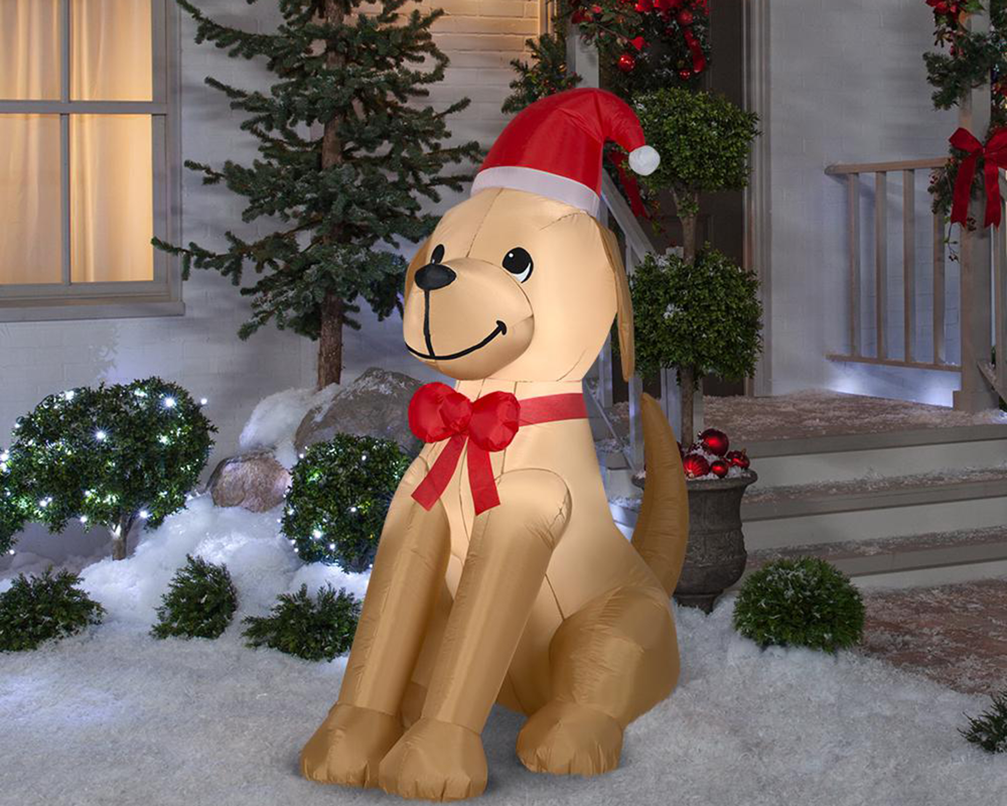 A 6 ft. inflatable Golden Retriever dog decoration with bow and Santa hat