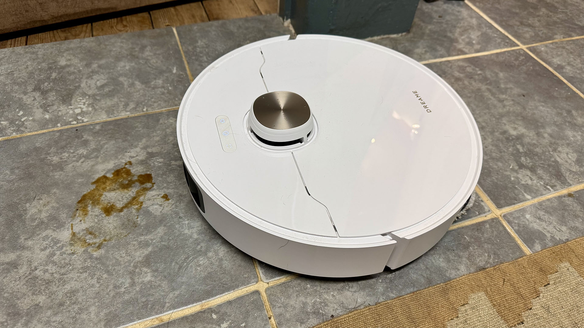 Dreame L40 Ultra robot vacuum mopping dried soy sauce off a hard floor