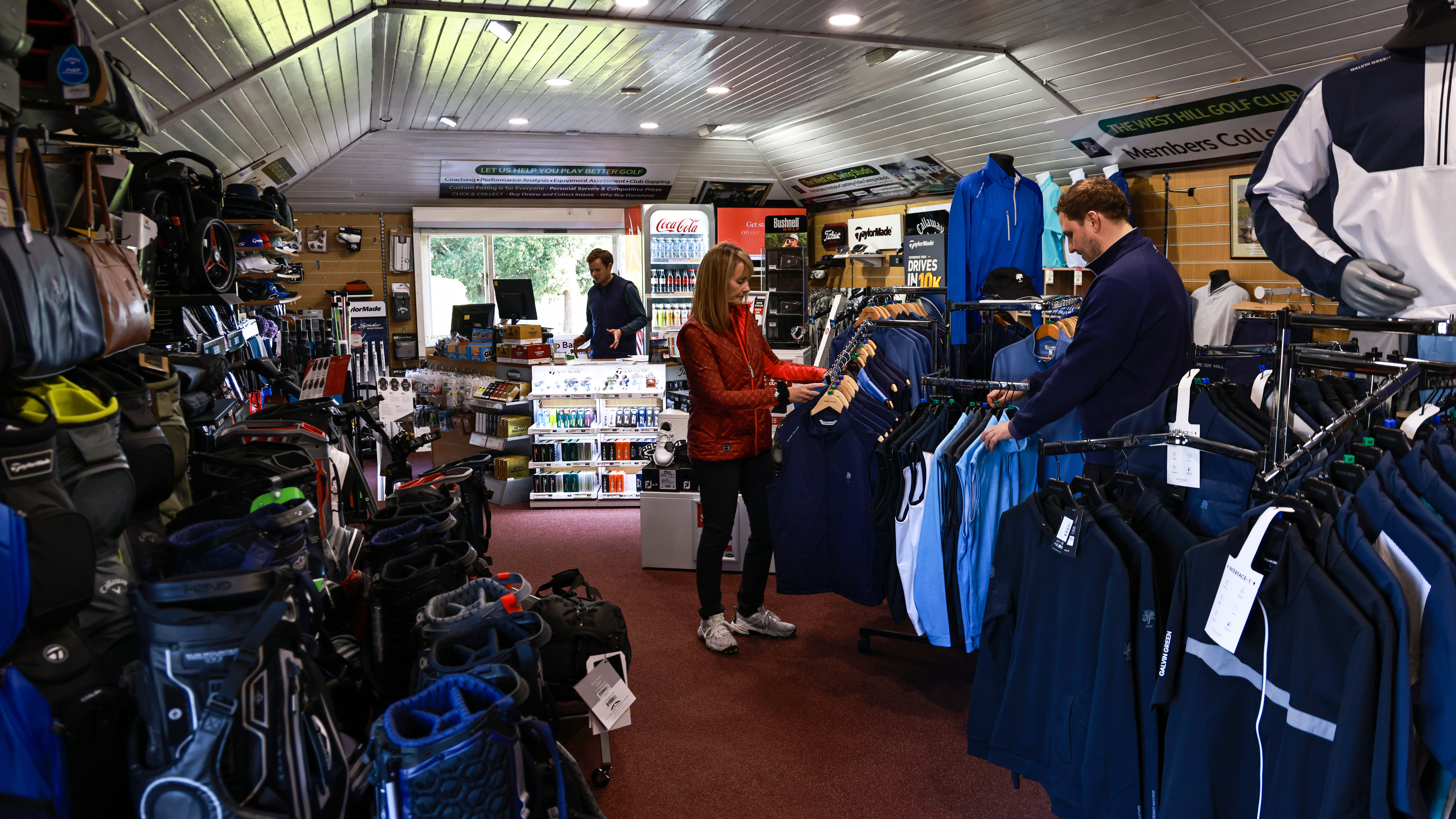 Golfers browsing in a golf pro shop