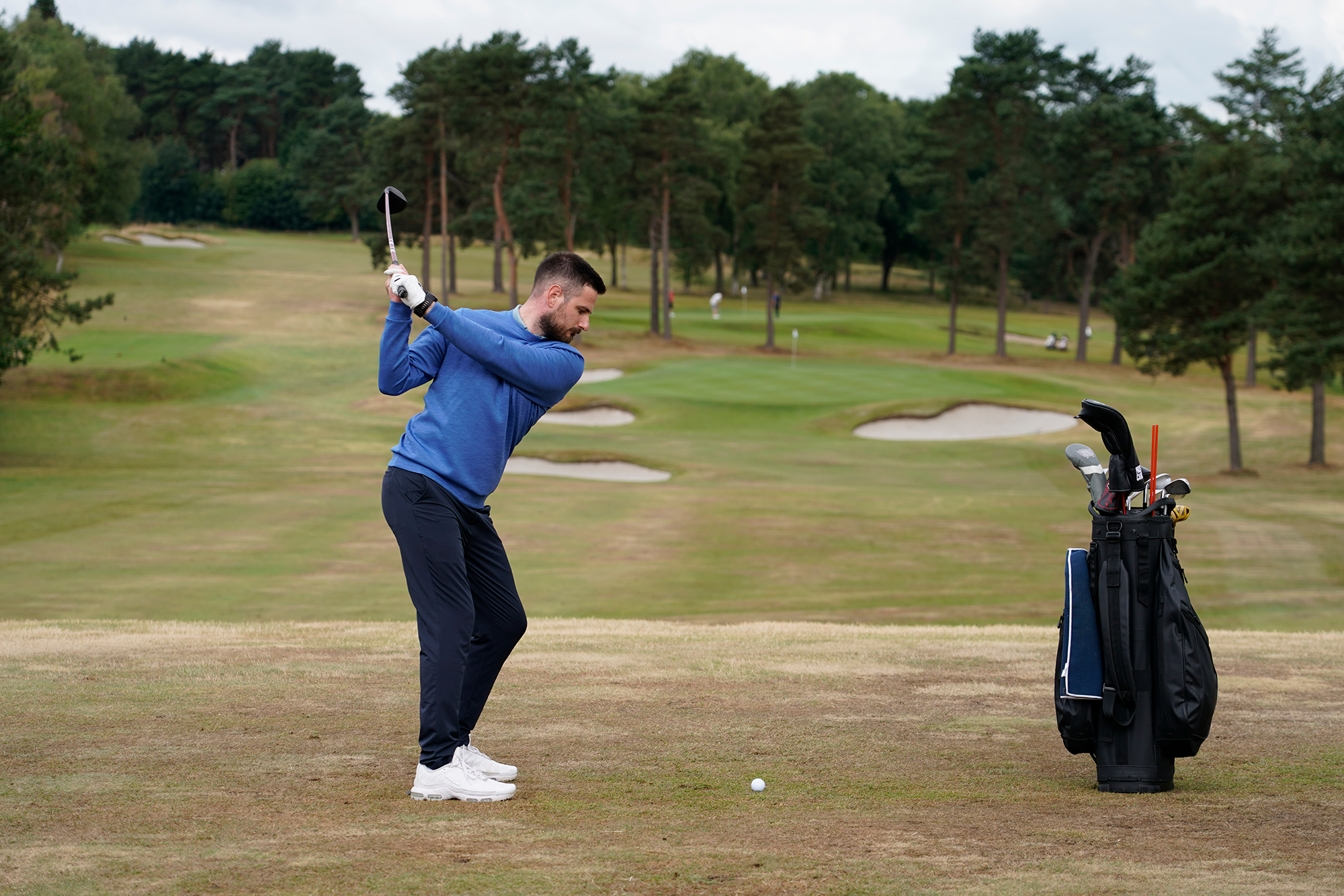 Baz Plummer at the top of his backswing before hitting a 3-wood off the fairway on the 1st hole at Sand Moor Golf Club