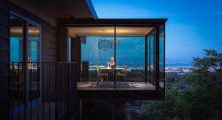 jewel box by red dot studio, a house jutting out of a leafy hill and looking out to views from large glazed side