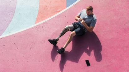 Man taking a Pilates class outdoors