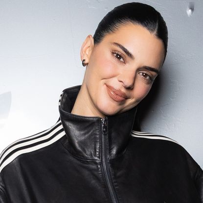 Kendall Jenner attended an Adidas event in a leather take on the track jacket trend and elongated Bermuda shorts