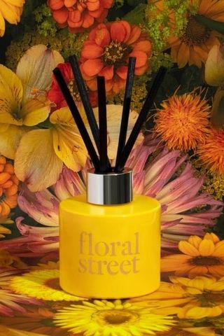 Floral Street Vanilla Bloom Reed Diffuser in yellow with flower background