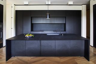 kitchen with black island and cabinets