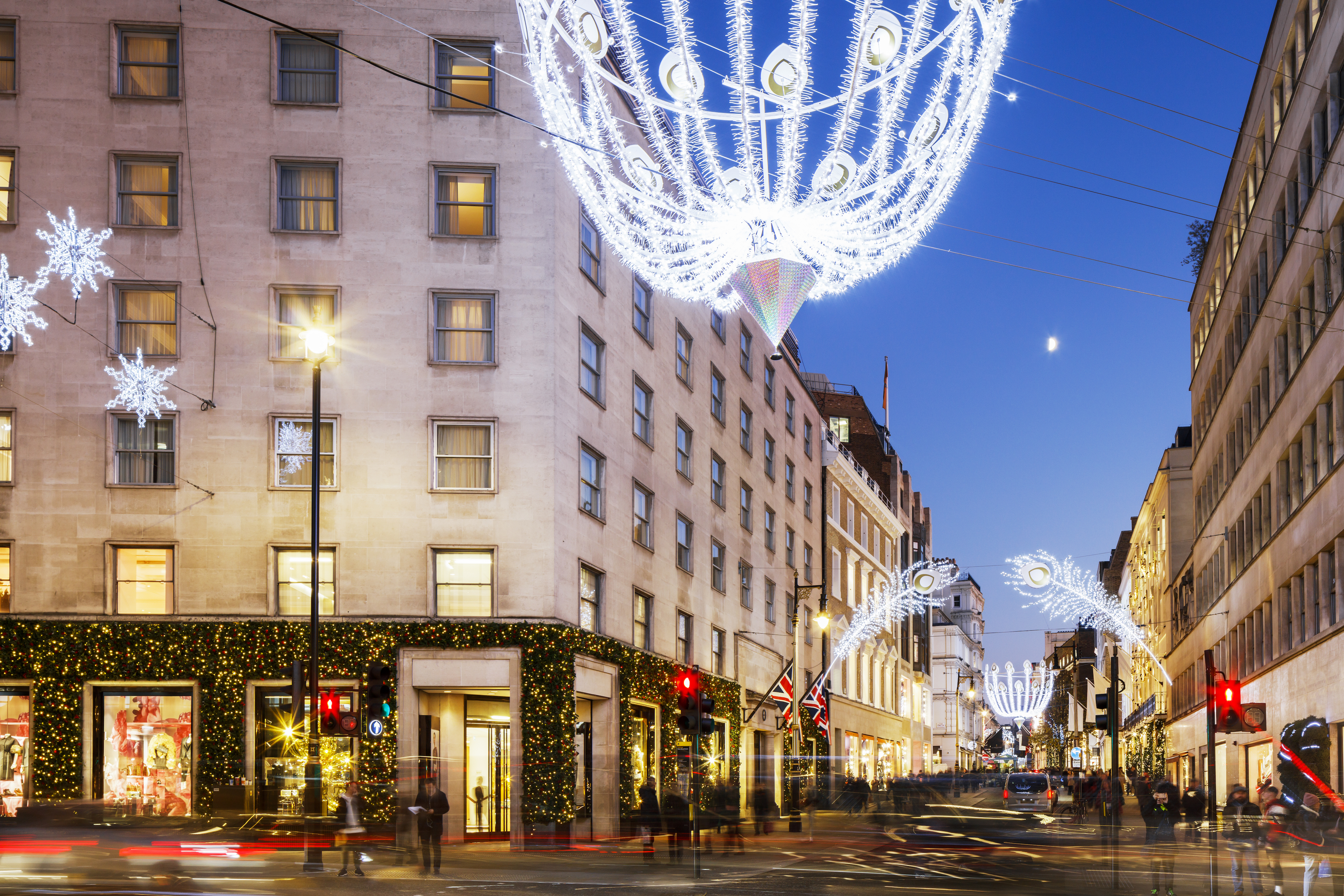 Christmas lights illuminate New Bond Street at dusk in Mayfair, London