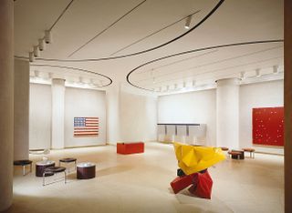 Bright, lit room with low stools and the American flag