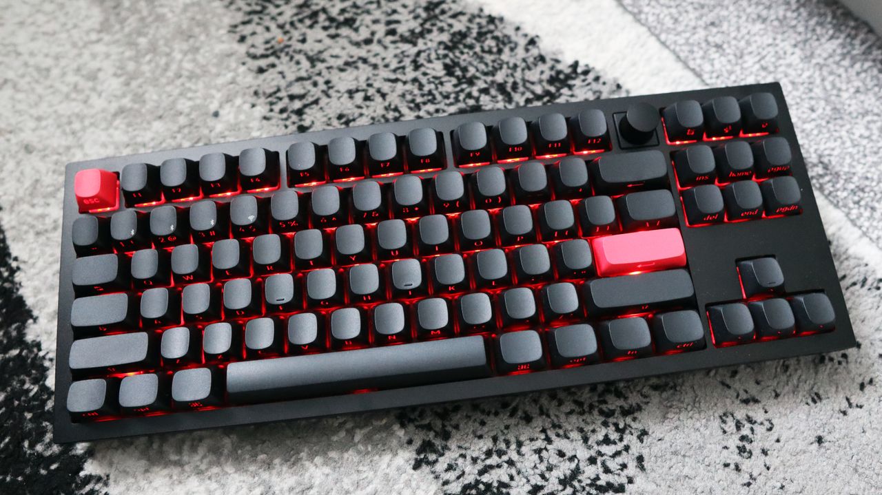 The Keychron Q3 Max gaming keyboard set-up on a desk with the RGB lighting enabled.