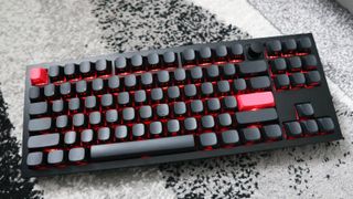 The Keychron Q3 Max gaming keyboard set-up on a desk with the RGB lighting enabled.