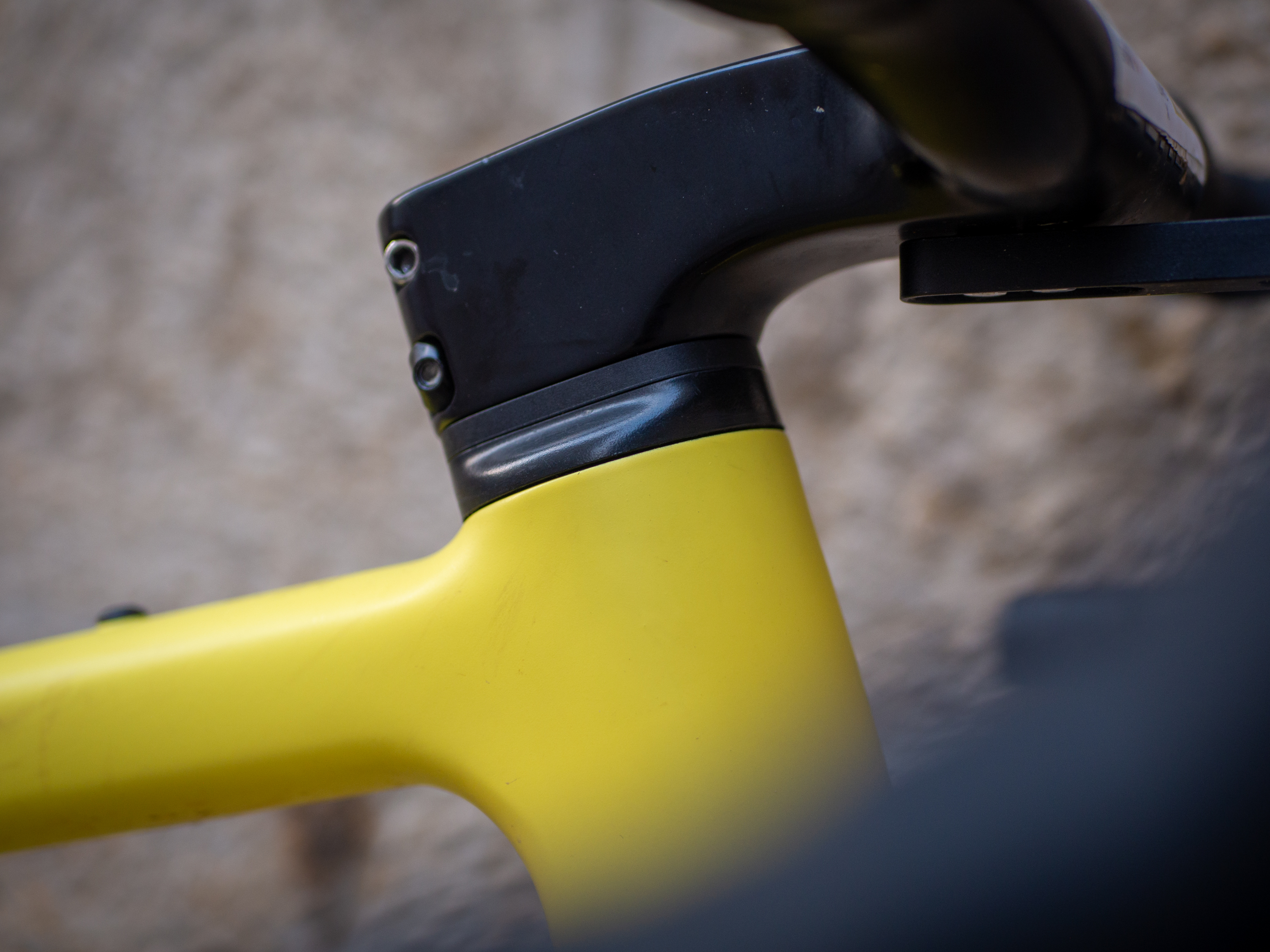 A yellow Guava Spot gravel bike leans against a wall