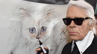 Karl Lagerfeld with drawing of his famous cat Choupette