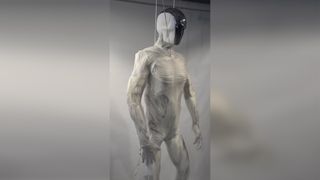 a photo of a robot with humanlike muscles and thin, white skin