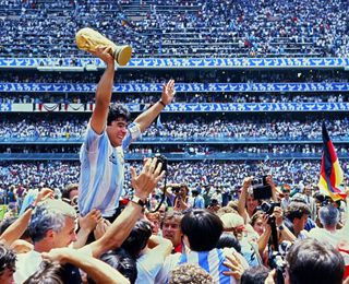 Argentina captain Diego Maradona holds aloft the World Cup trophy after victory over West Germany in Mexico 1986.