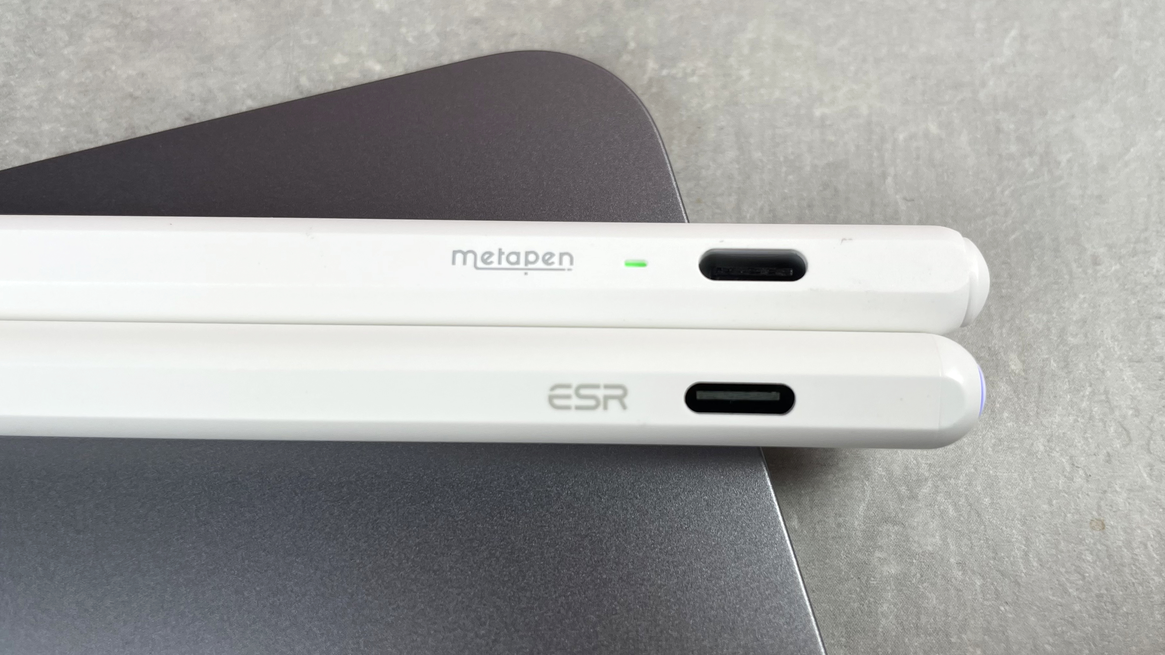 A close-up of the ends of the Metapen Pencil Air8 and the ESR Geo Digital Pencils, which are pictured lying next to each other.